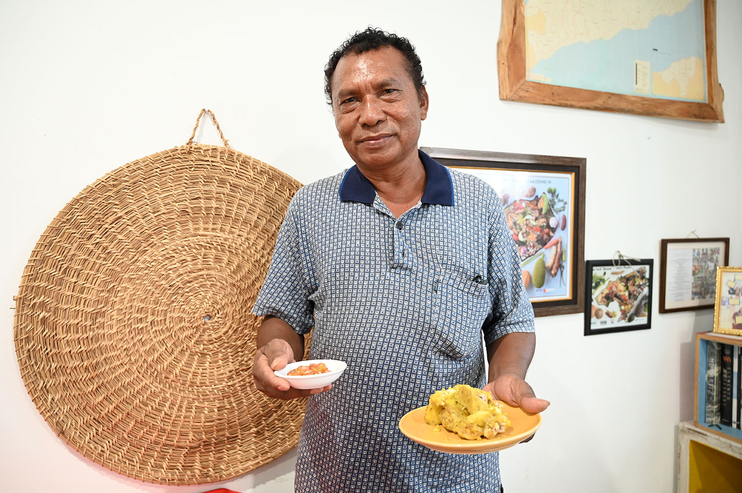 Mr Paulo Soares da Cruz holds up a plate of taro