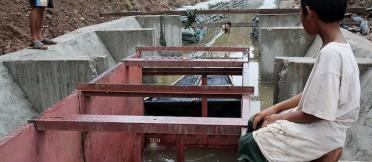 A boy overlooks a fish passaged structure