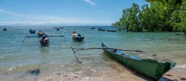 Fishing boats in a clear way bay on a sunny day with blue skies