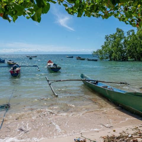 Fishing boats in a clear way bay on a sunny day with blue skies